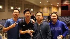 Seniors and Karaoke Club co-presidents Iden Han and Richard Zhu, junior Binhui Jiang and senior and co-president Kaixin Hou pose in the auditorium during a weekly meeting.