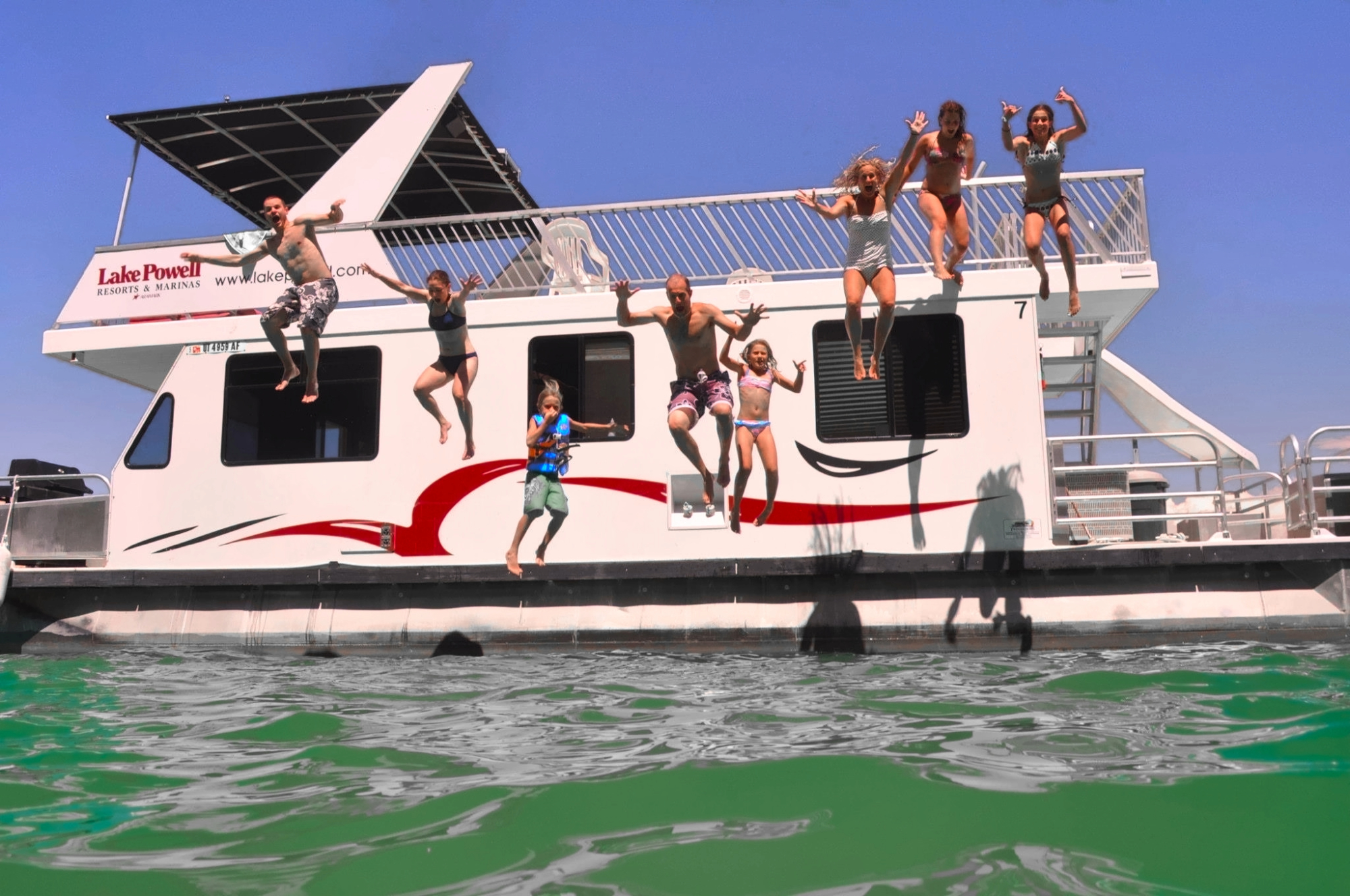 The Goetz family jumps off of a houseboat in Lake Powell, Arizona. (Photo courtesy of Laura Goetz)
