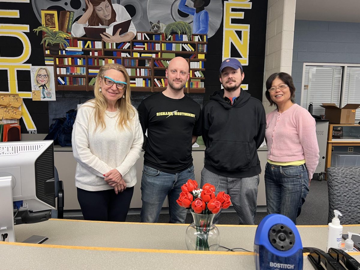 RM's media specialists pose behind the front table at the media center.