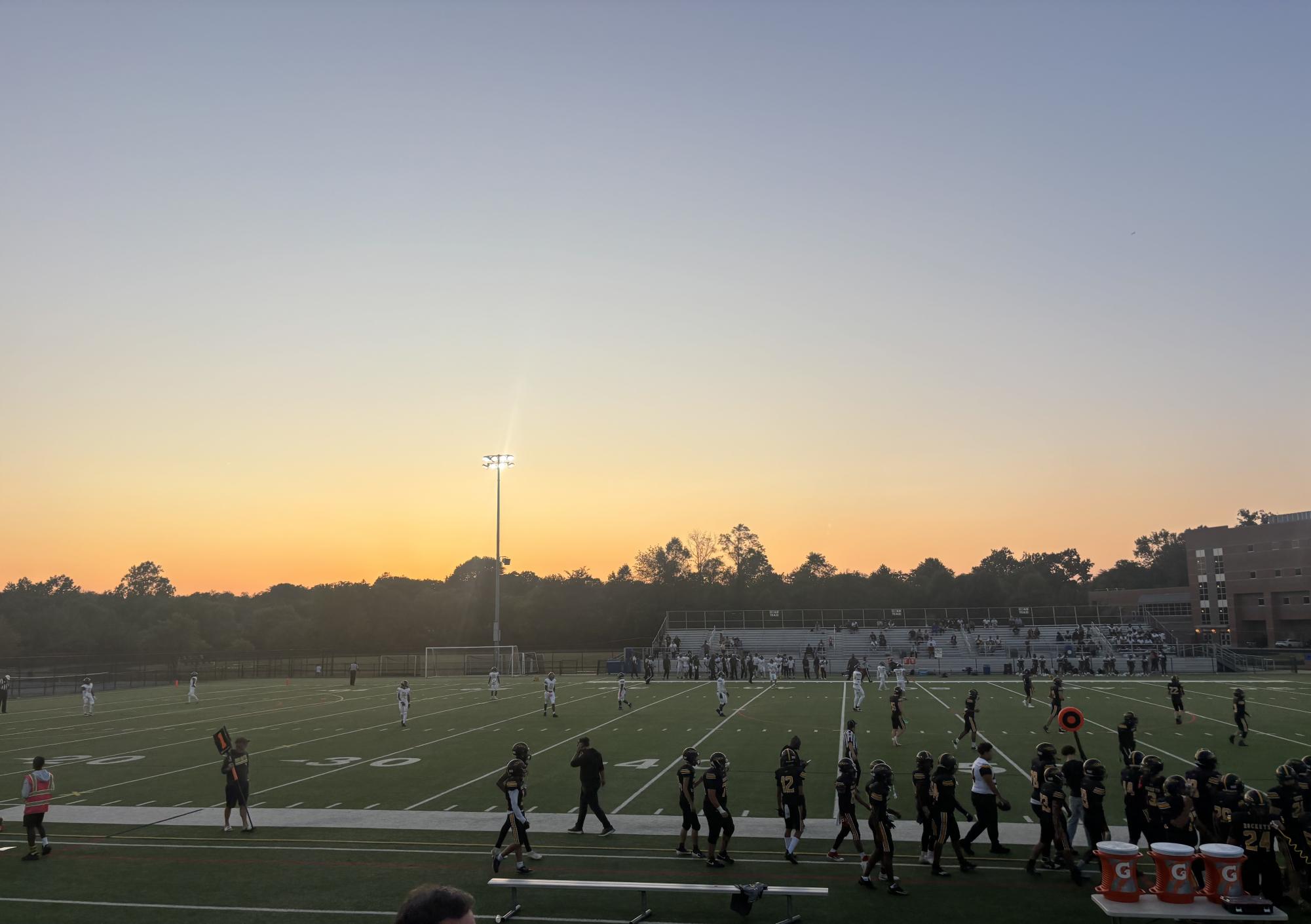 The sun sets over a Friday night football game at RM.