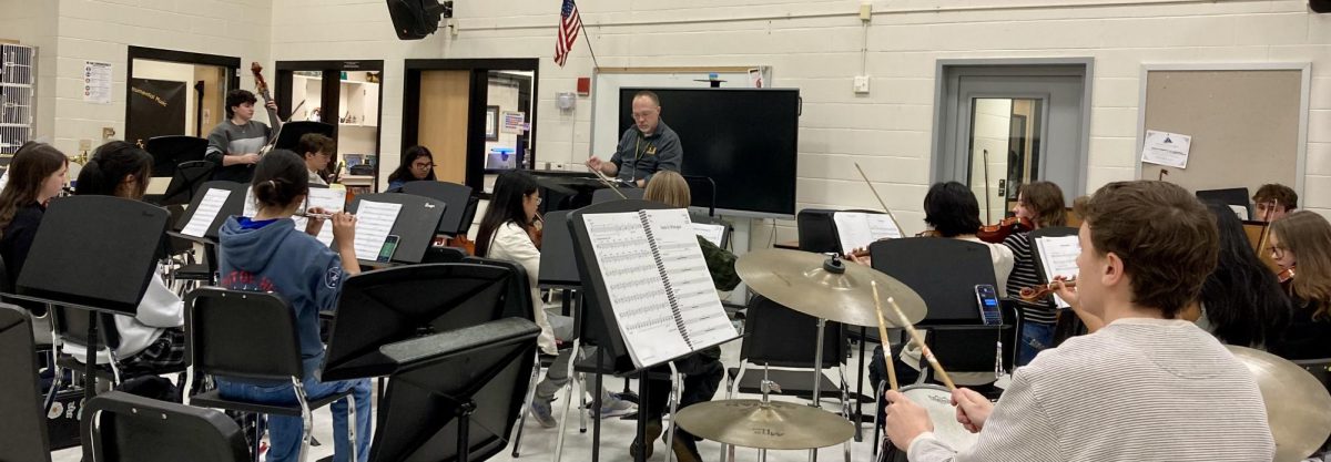 Dr. Perry leads a lunchtime rehearsal on Oct. 21 as the pit orchestra comes together to perform the overture—the opening music.