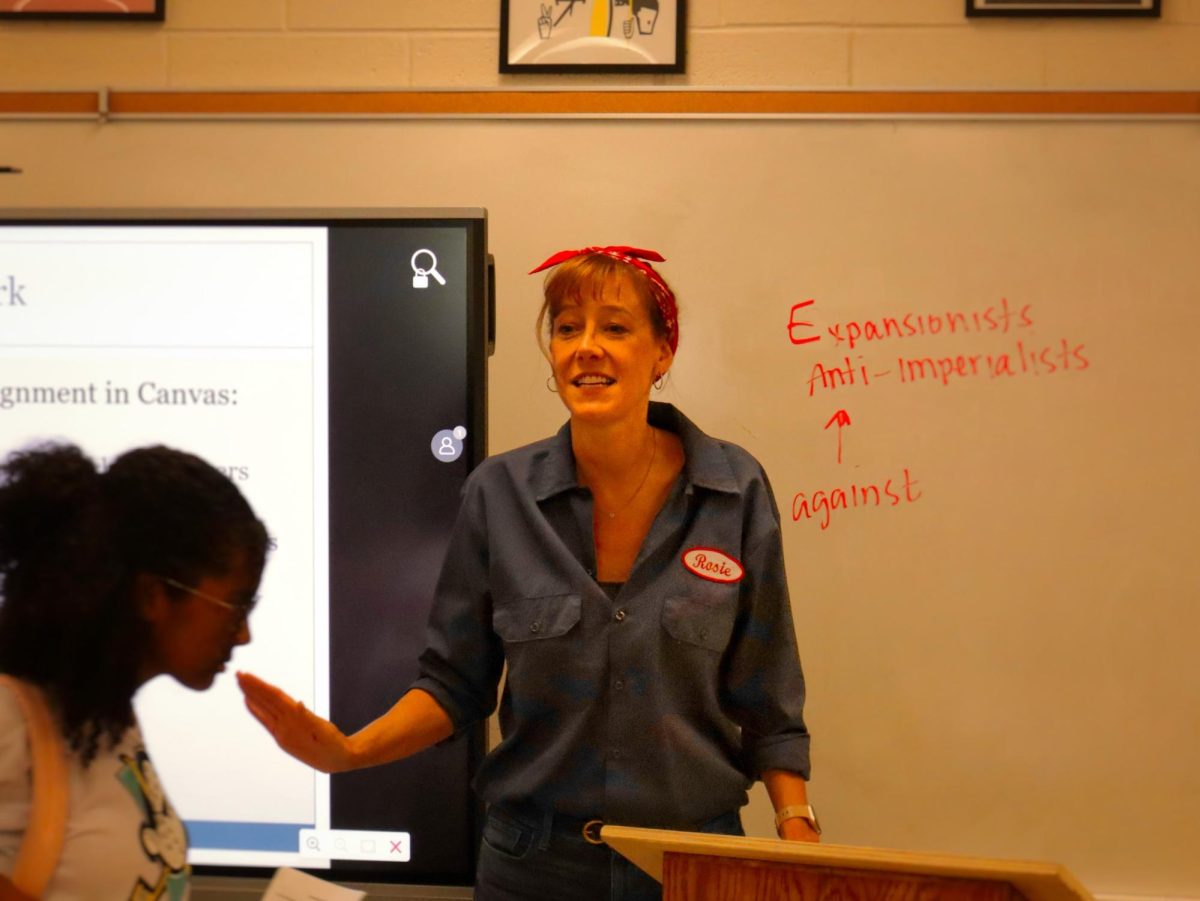 Social studies teacher Lisa MacFarlane is dressed up as Rosie the Riveter. “Rosie the Riveter is a symbol of working women during World War II,” she said. She has a poster of Rosie in her room, and is excited because her costume is the perfect blend of the subjects she teaches: AP US History and Women’s Studies. Her favorite costume in the past was when she dressed up as a hippie. “I try different historical decades,” she said. 