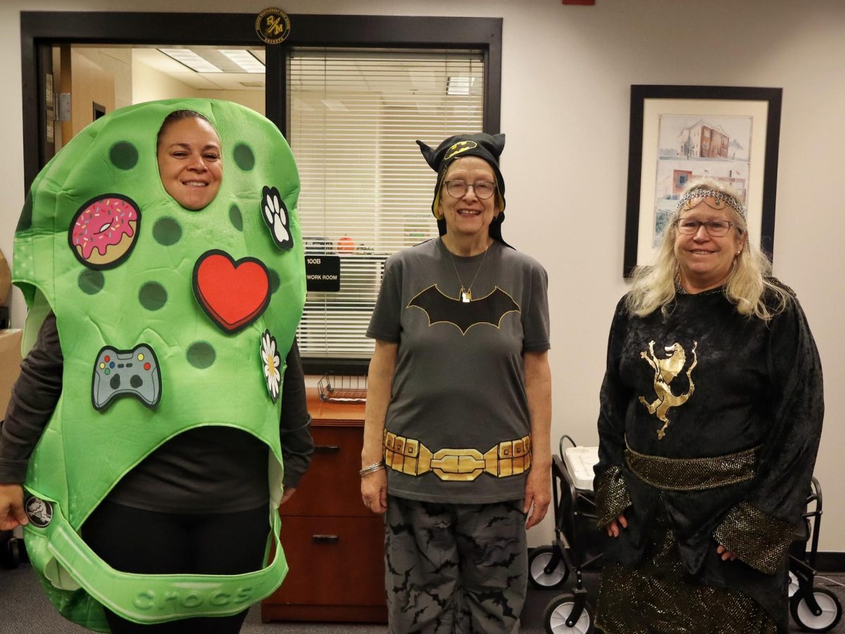 Administration secretary Laura Hermansdorfer and main office secretaries Mary Ayala and Susan Aubertin pose in their costumes in the main office.