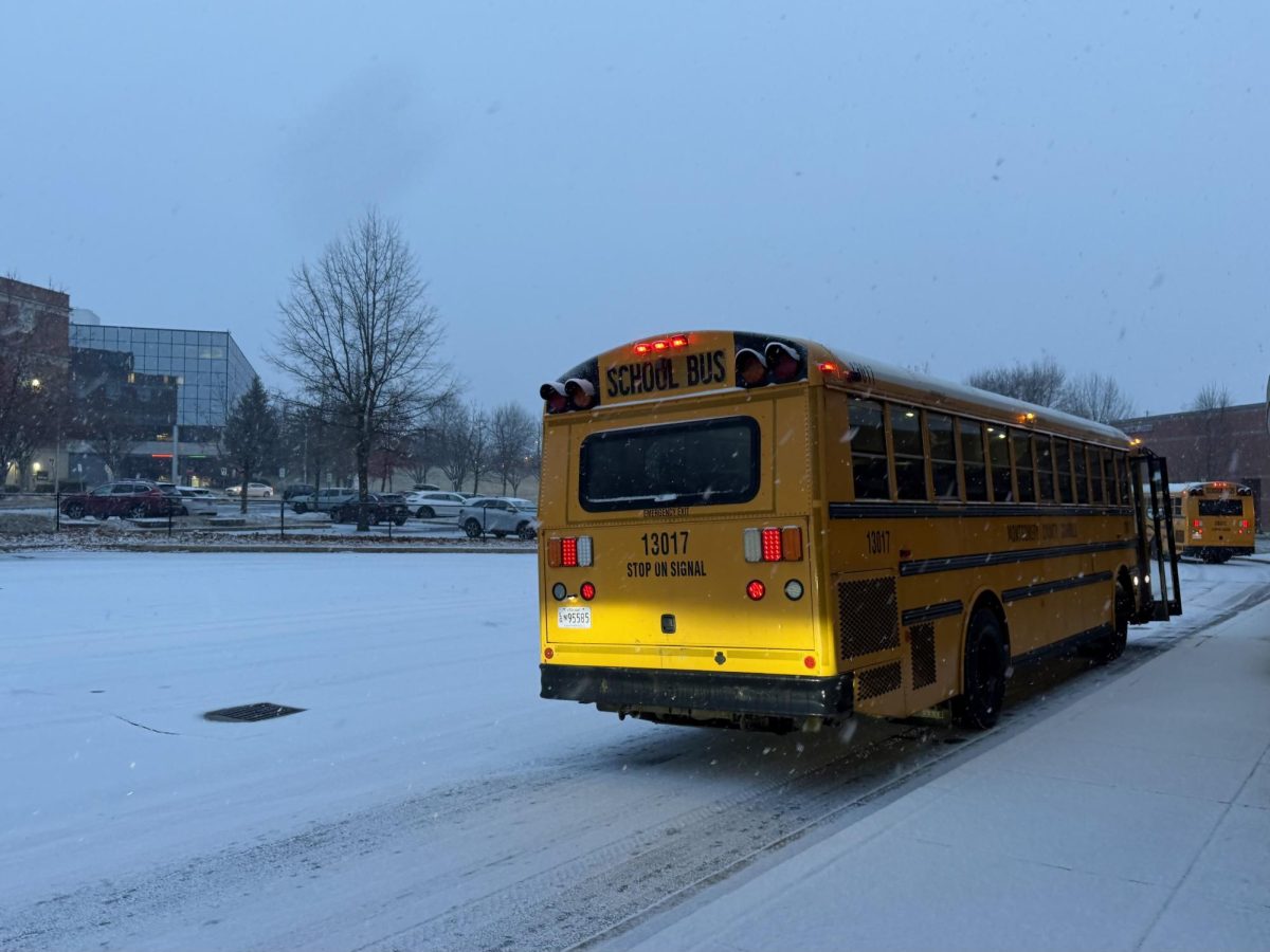 Snow flurries fall and blanket the ground in front of the RM building as buses pull up to the school’s
driveway on the morning of Friday, Dec. 5. The district’s decision to keep schools open despite the snow
accumulation covering roads has sparked backlash throughout MCPS, including here at RM.