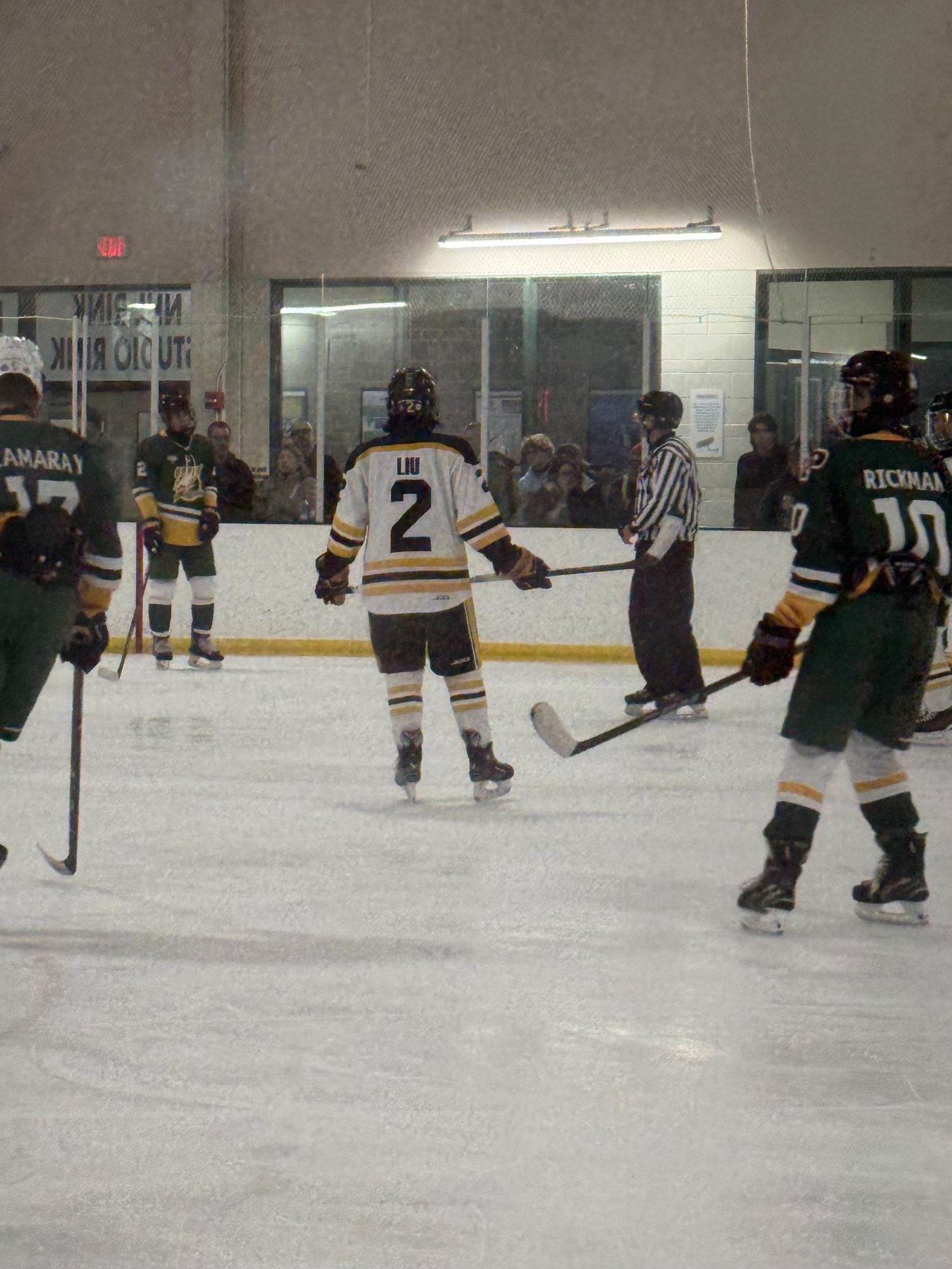 Junior Caleb Liu skates up the the face off dot and prepares to due a face off.