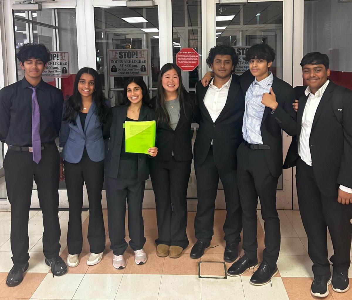 Junior Gautam Ganesh and freshmen Anaya Menavan, Shibani Mishra and Ella Wan pose with three Poolesville students before their tournament. (Picture courtesy of Gautam Ganesh)