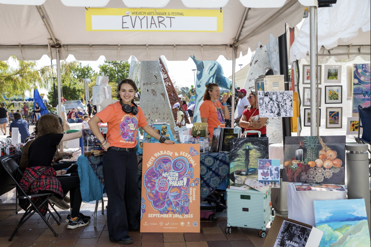 Senior Evyia Makrodimitri showcases her booth at the Wheaton Arts Parade. (Photo courtesy of Evyia Makrodimitri)