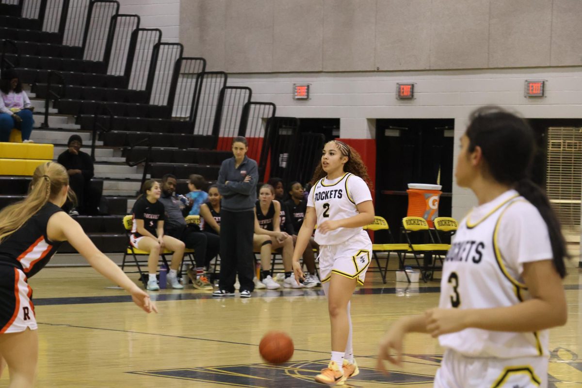 Junior Ava Ruggeri dribbles the ball down the court, pausing at the half-court line to decide on a play. Ruggeri played the most minutes for the Rockets in their 60-14 win on Jan. 14.