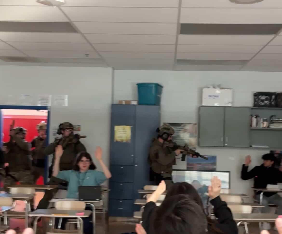 In this photo from Wootton student Alena Pascal, armed police display rifles as they work to clear a classroom at Wootton.