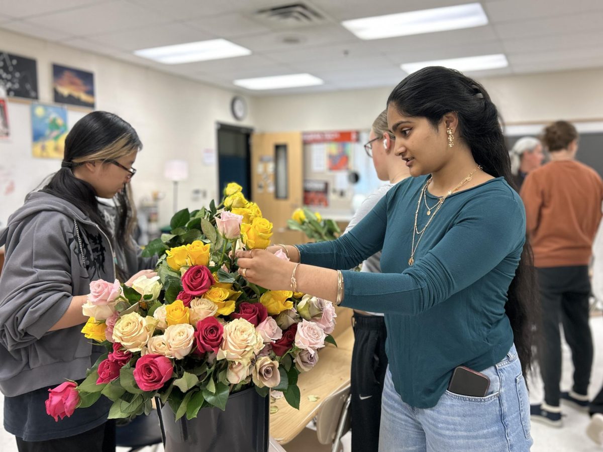 Senior Esha Sharma removes thorns from roses in the activities room on Thursday afternoon.