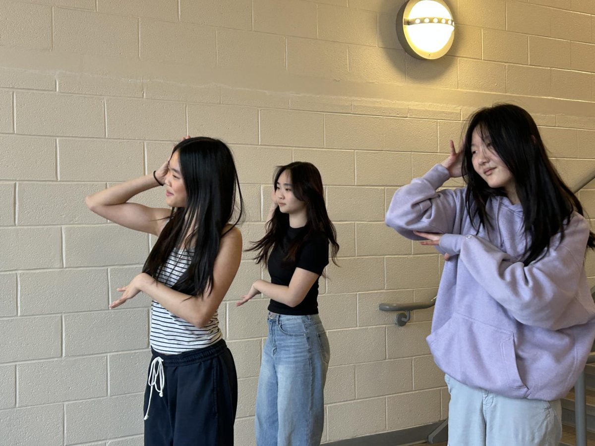 DANCING ALONG TO "NOT CUTE ANYMORE" by ILLIT, sophomores Silvia Choi, Anna Wu, and Leah Kim practice their routine for their Instagram account @dynamicdancetrio. 