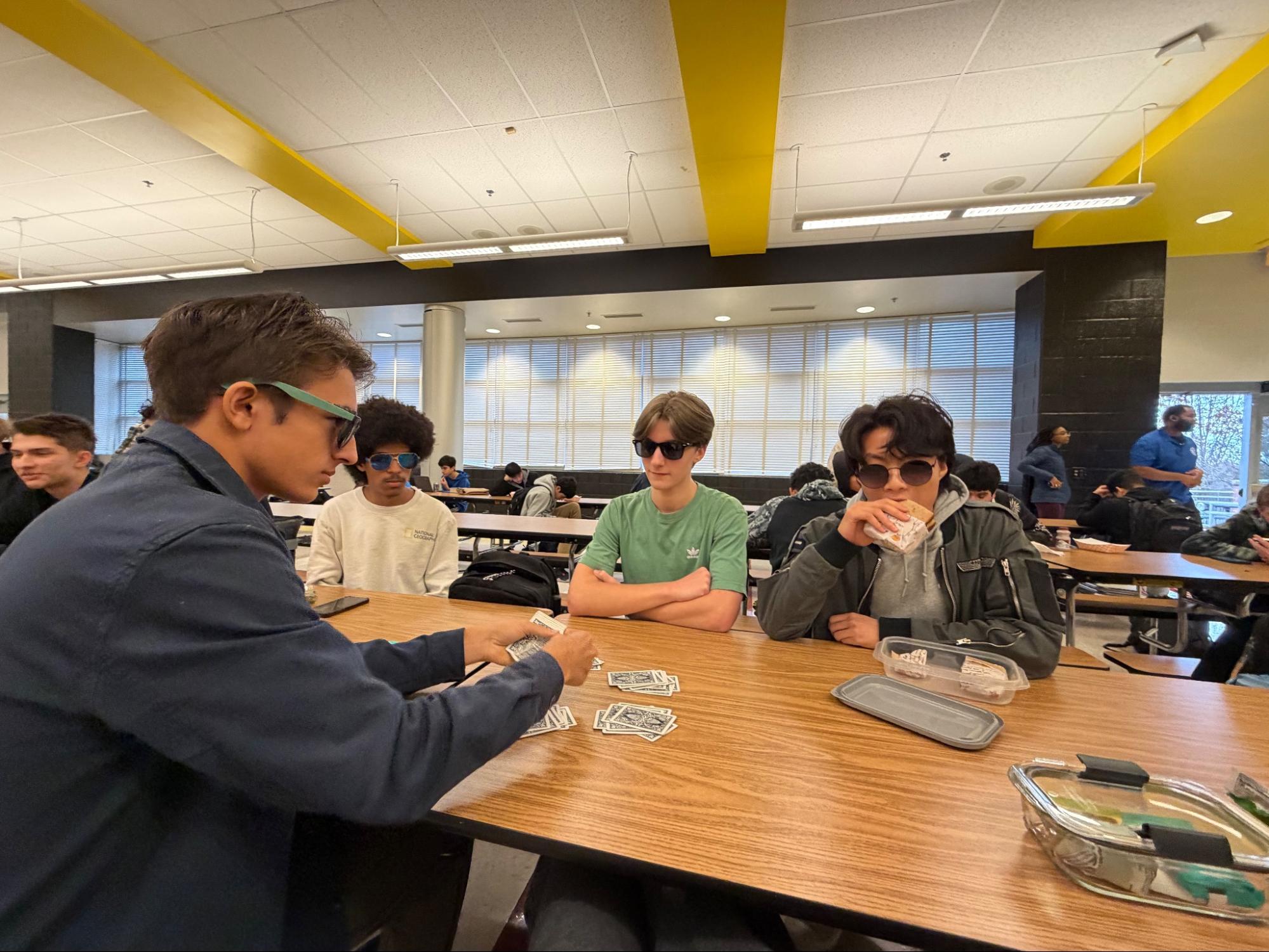 Juniors Inder Haugen, Brice Snyder, Ethan Trumbull, and Elliot Choi sit at lunch with sunglasses on, the first daily safety of each Spoon Assassin cycle. 