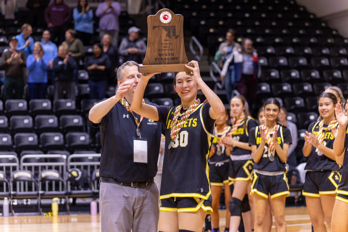 Katie Diao hoists the Maryland Class 4A State Finalist trophy at the conclusion of the State Championship game. 