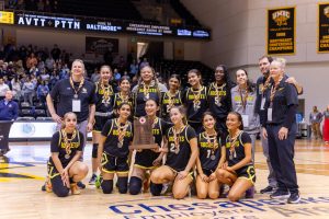 The Rockets pose on the UMBC basketball court with their State Finalist trophy after the game.