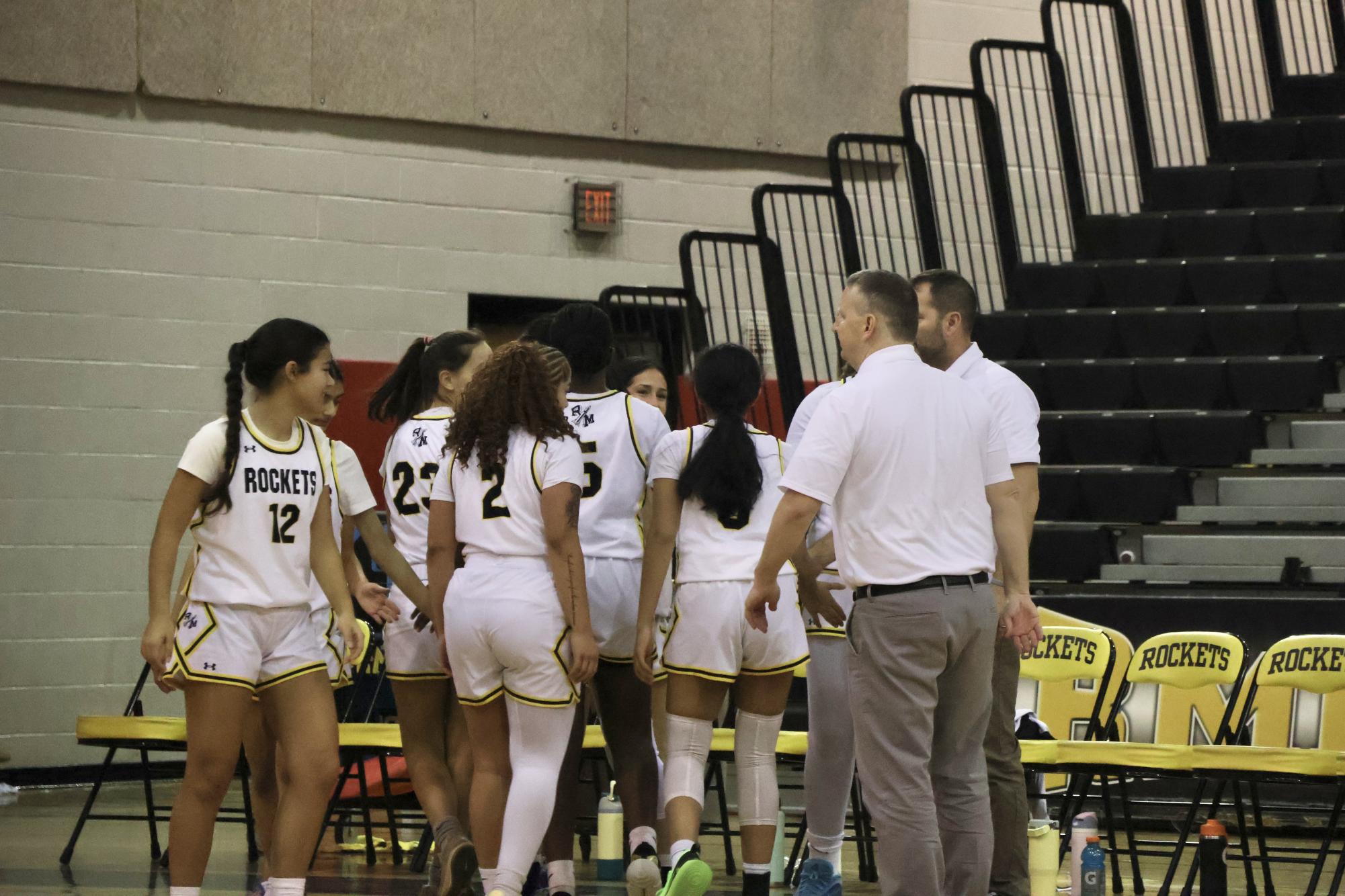 The Rockets huddle before the tip-off.