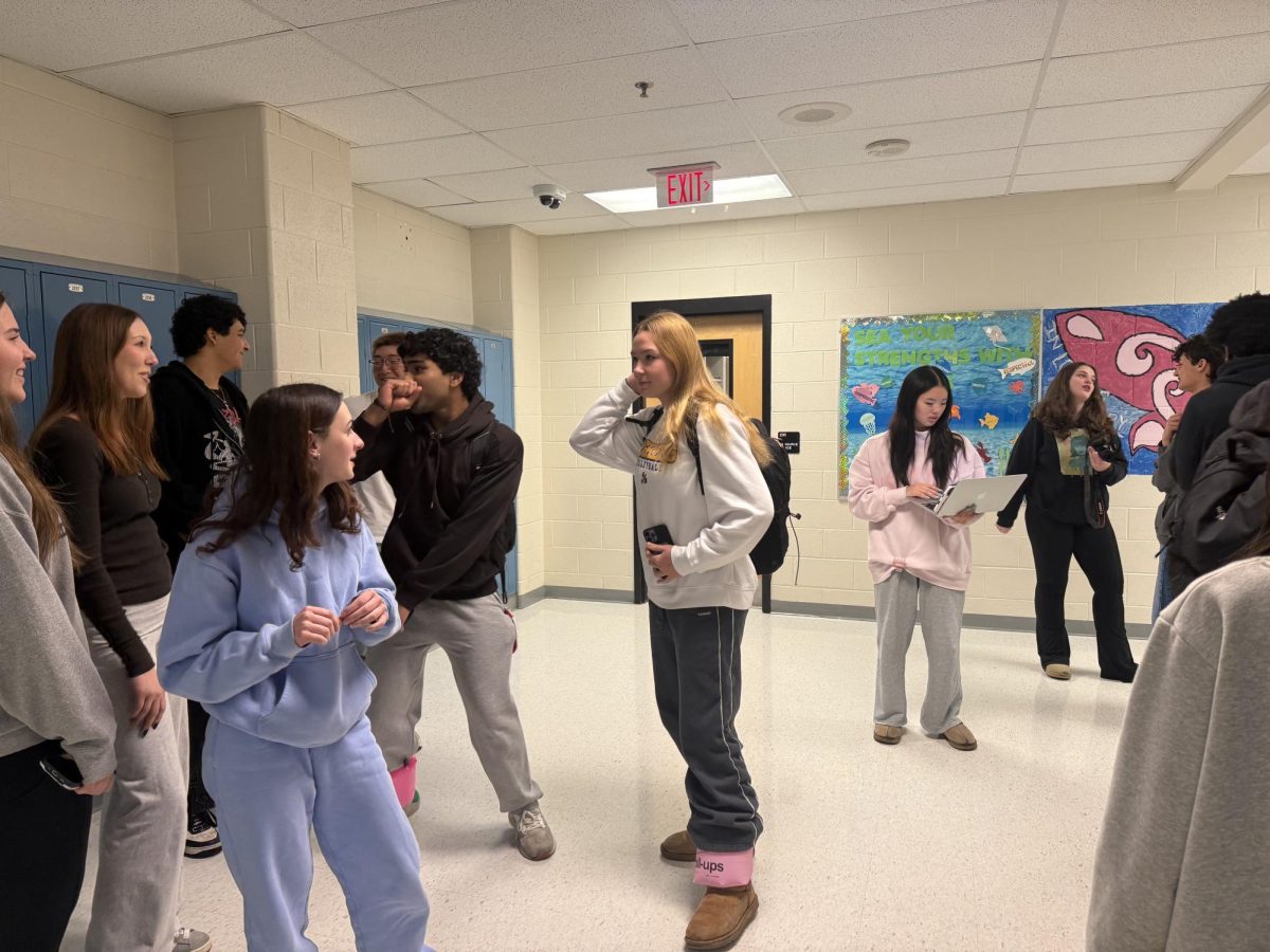 Students gather in the hallway while waiting for their turn to take photos for senior superlatives that will appear in the Richard Montgomery High School yearbook. 
