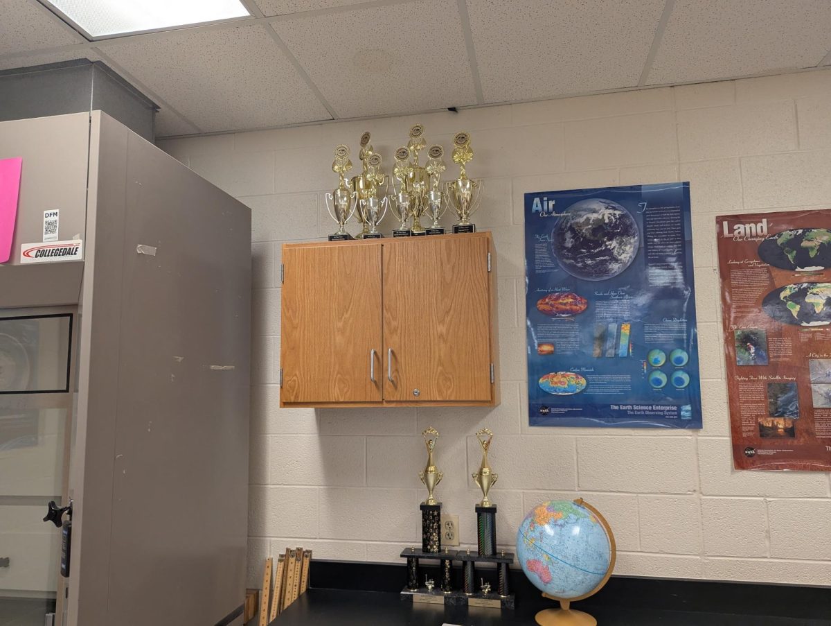 The many awards that the team has won are displayed in the back of Mr. Decker's classroom.