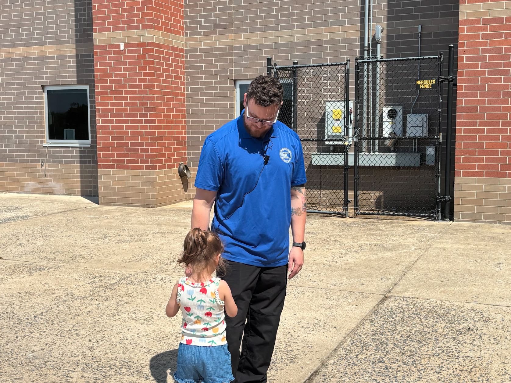 Walking around the school with his daughter Olivia, security staff member, Mr. Tim Thompson, enjoys the sunny day. 