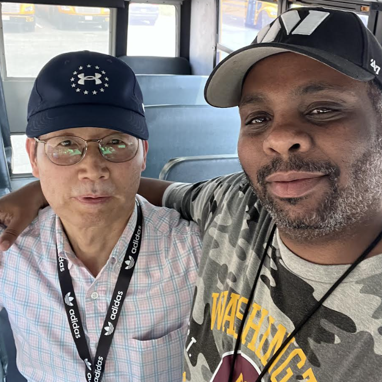 Bus driver Theodore Frost and his bus attendant, Mr. Ham, pose for a selfie inside their bus. (Photo courtesy of Theodore Frost)